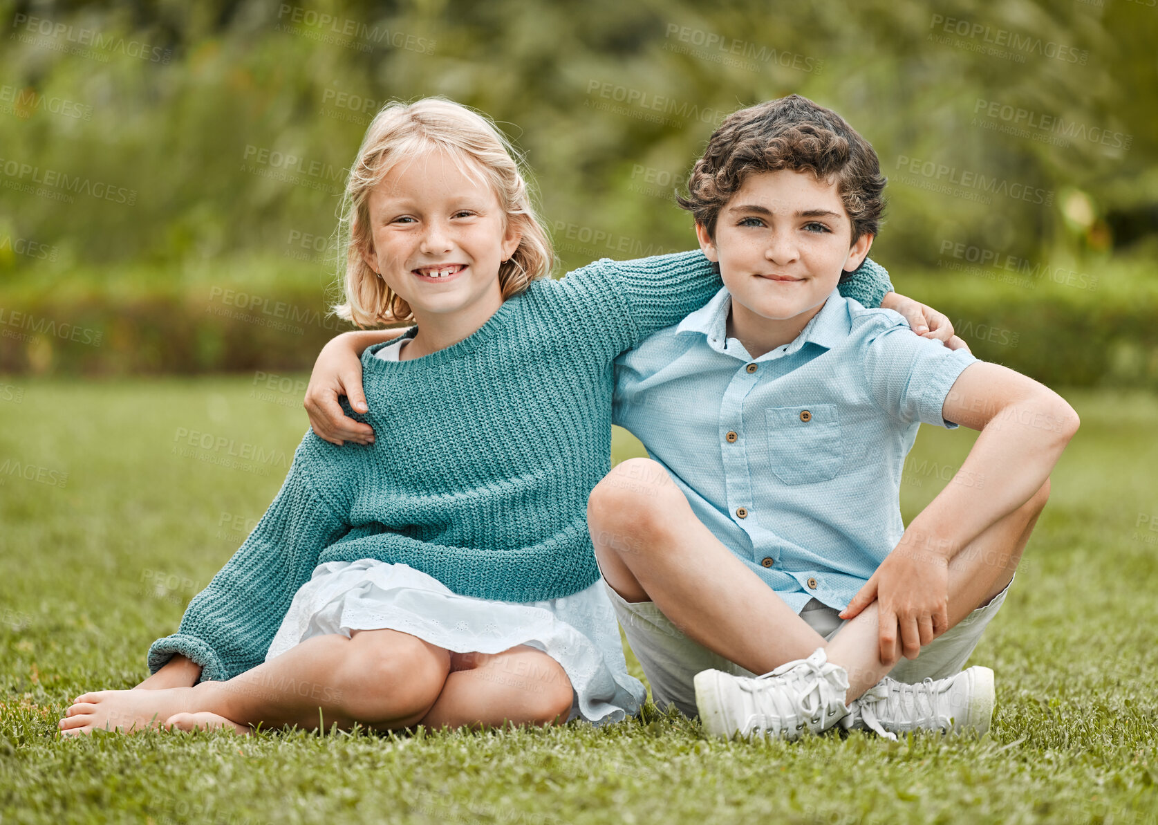 Buy stock photo Shot of an adorable little girl and boy sitting together outside