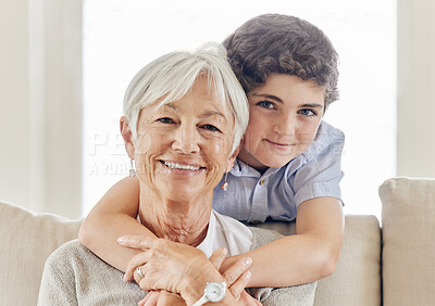 Buy stock photo Shot of a mature woman bonding with her grandchild on the sofa at home