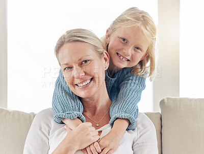 Buy stock photo Shot of a young mother and daughter bonding on the sofa at home
