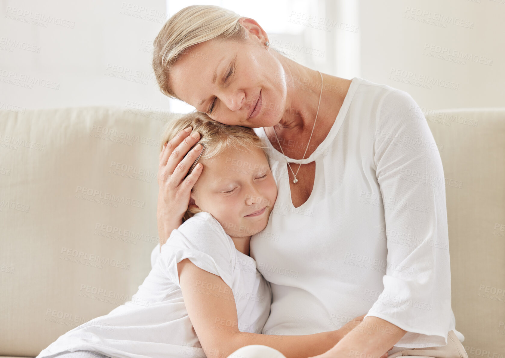 Buy stock photo Mother, daughter and hug in home for bonding, love and support child in relationship on couch. Mama, girl and embrace kid for trust on weekend, family house and connection for care in living room