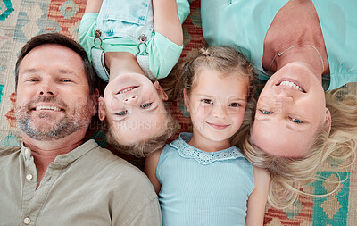 Buy stock photo Shot of a couple and their two daughters lying in a row