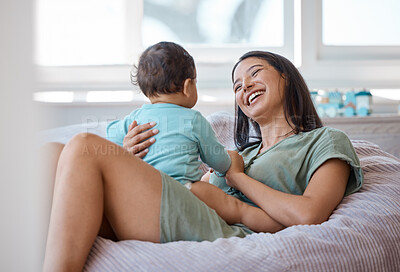 Buy stock photo Mom, laughing and smile with baby in home for love, child care and support of happy development. Mother, bond and relax with newborn infant on bean bag in kids nursery room for quality time together