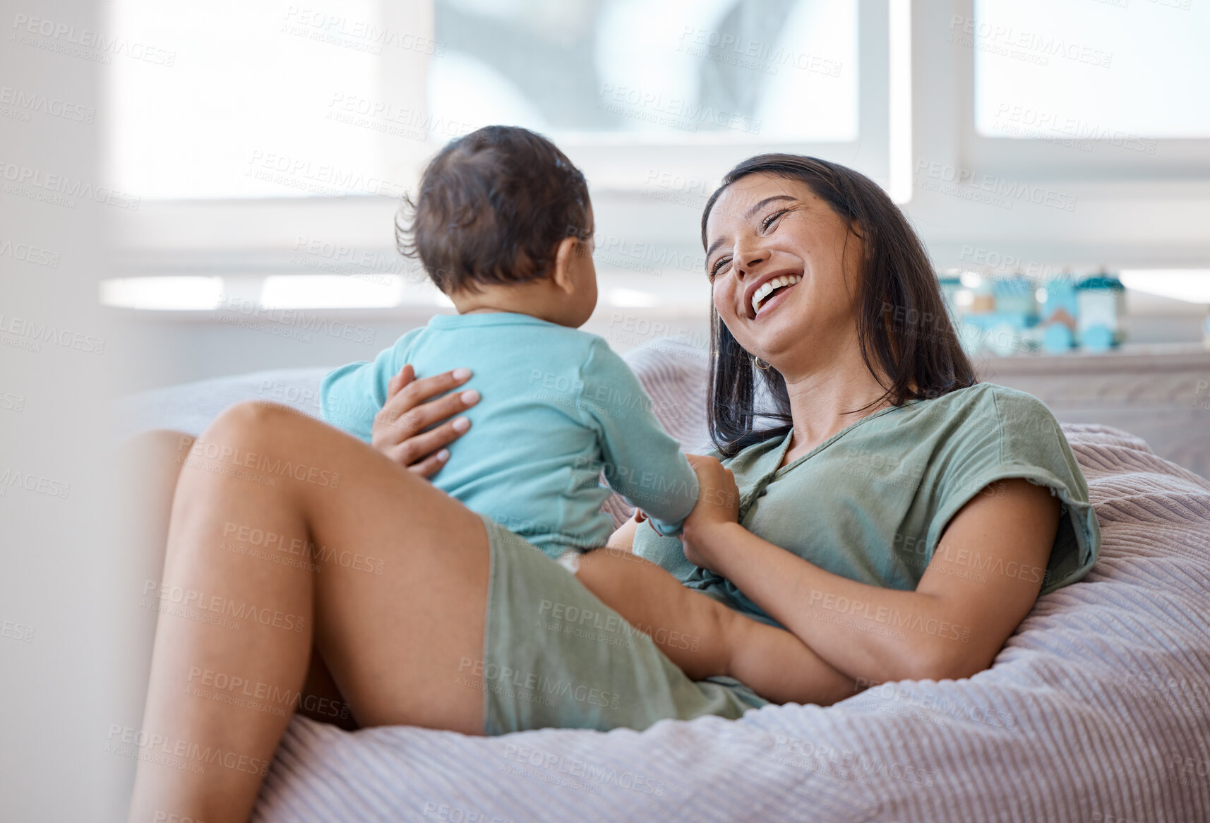 Buy stock photo Mom, laughing and smile with baby in home for love, child care and support of happy development. Mother, bond and relax with newborn infant on bean bag in kids nursery room for quality time together