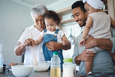 Buy stock photo Shot of a woman baking in the kitchen with her son and two grandchildren