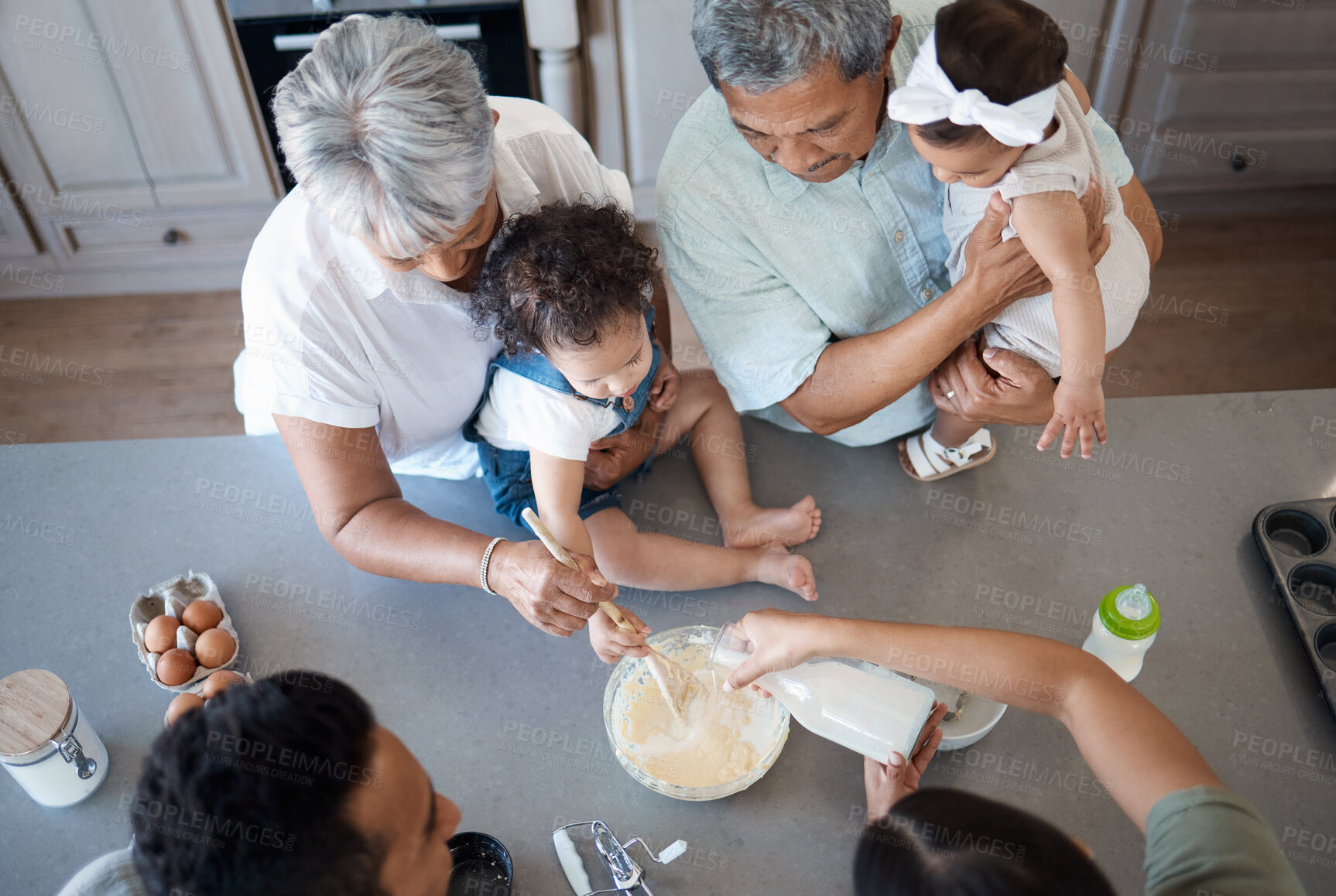 Buy stock photo Above, learning or toddler baking with big family, lesson or bowl for bonding or food in home. Mom, dad or senior grandparents teaching kid cooking skills for development, dessert or breakfast meal