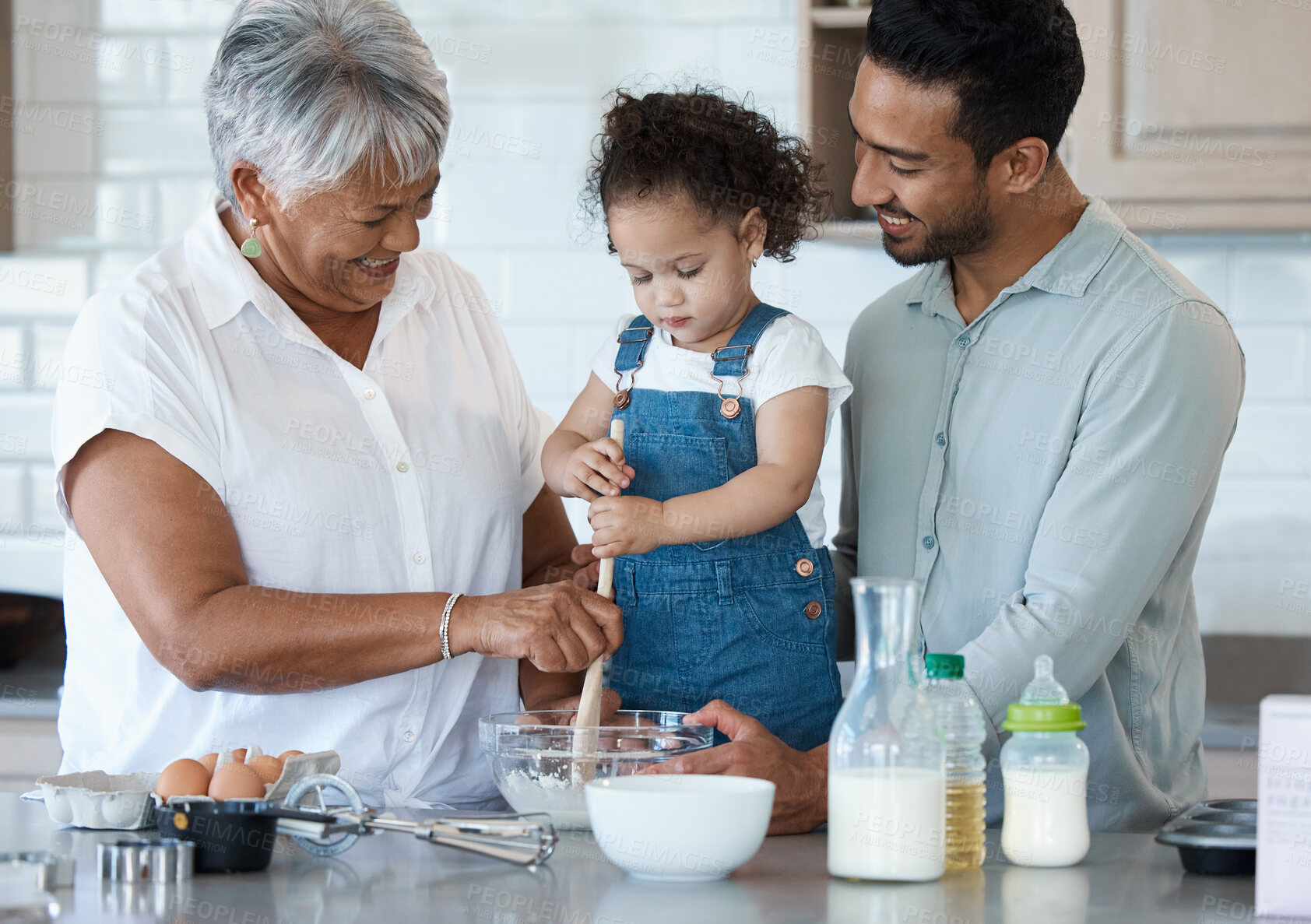 Buy stock photo Happy family, baking and child in kitchen for learning, skills development and making cupcakes for Thanksgiving. Grandmother, man and kid at home with secret recipe, bonding and generations with help