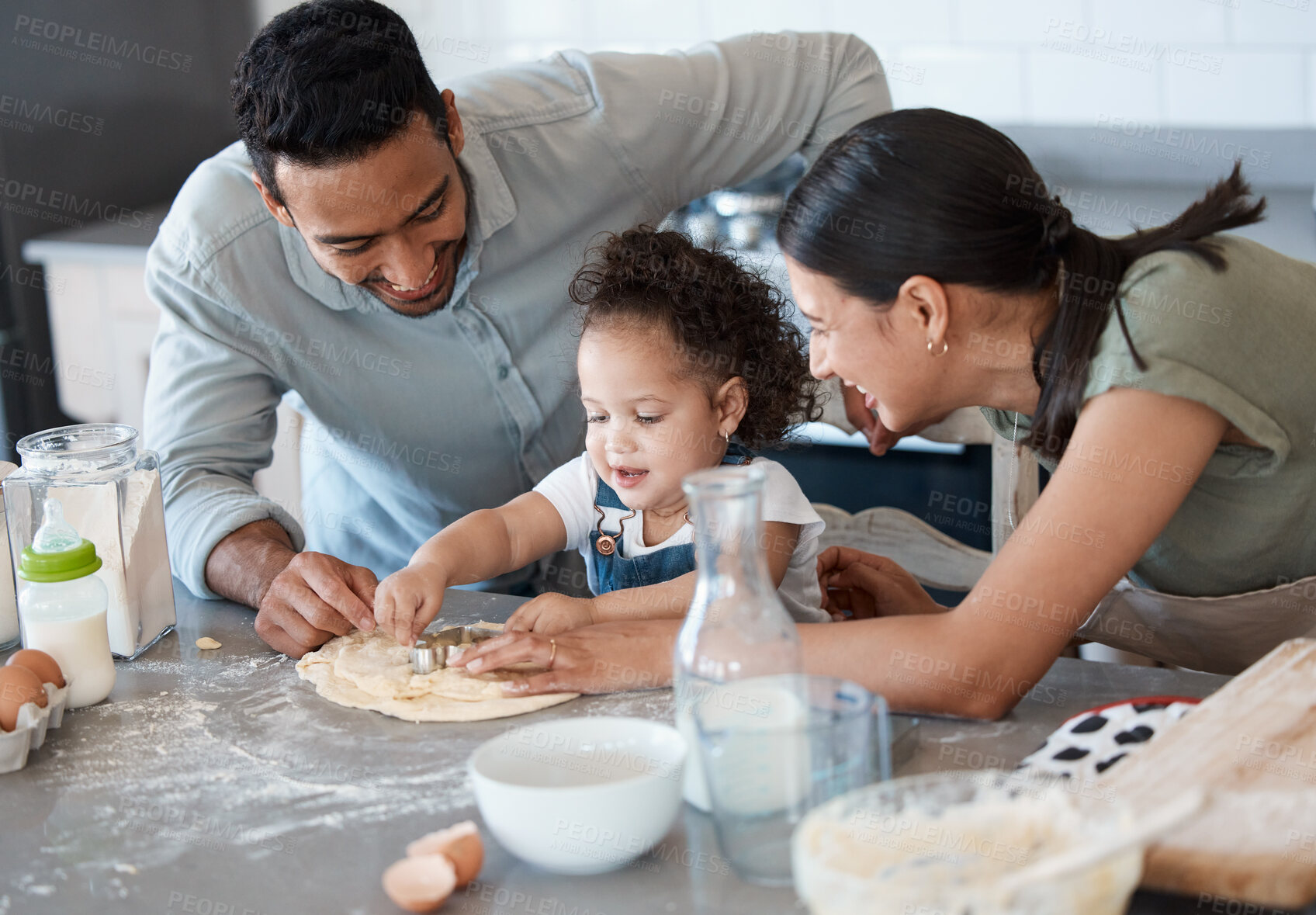 Buy stock photo Shot of a couple baking with their toddler at home