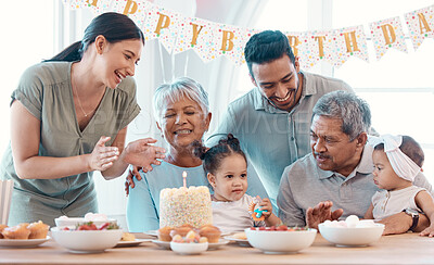 Buy stock photo Shot of a family celebrating a birthday together at home
