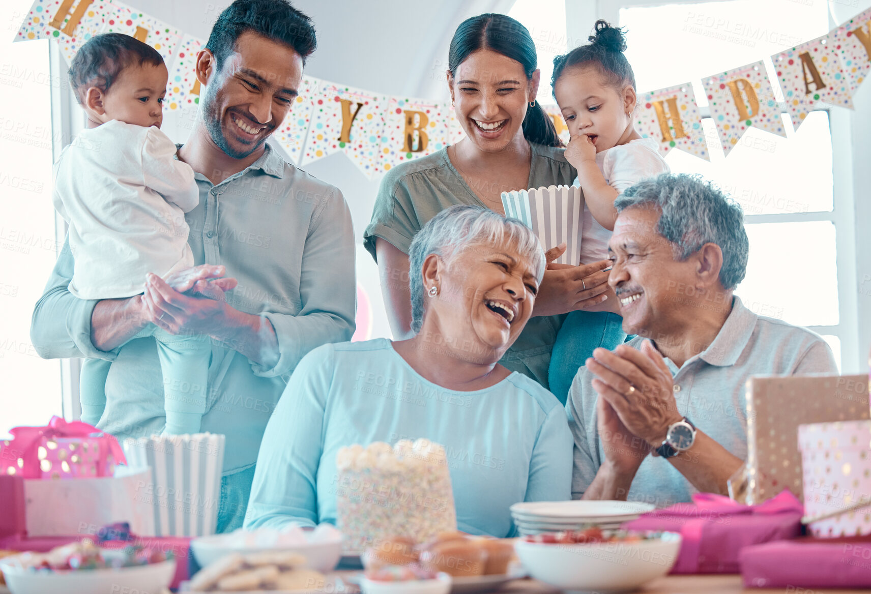 Buy stock photo Big family, senior couple and laughing with party, cake and love for home birthday celebration. Mature man, woman and parents with grandchildren, support and event for retirement and holiday bonding