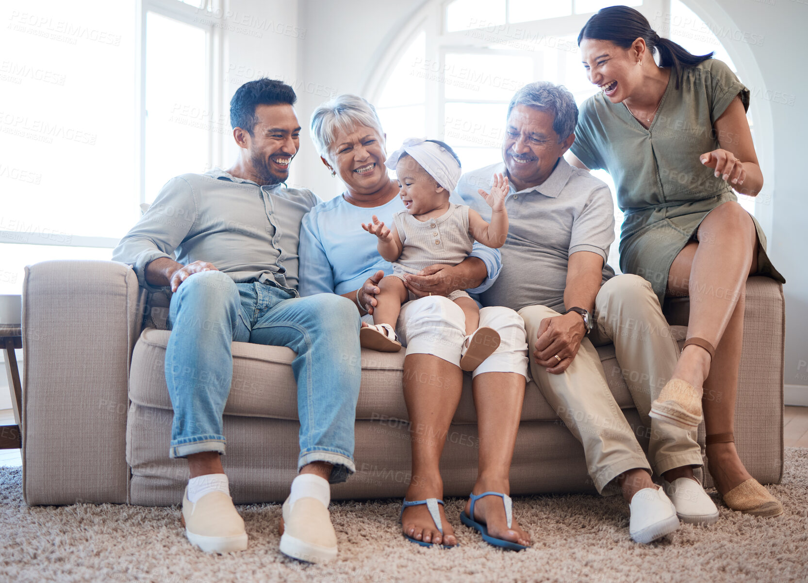 Buy stock photo Happy, laughing and baby with parents and grandparents in living room for playing and bonding together. Generations, relax and infant with mom, dad and senior people for family time on sofa in home.