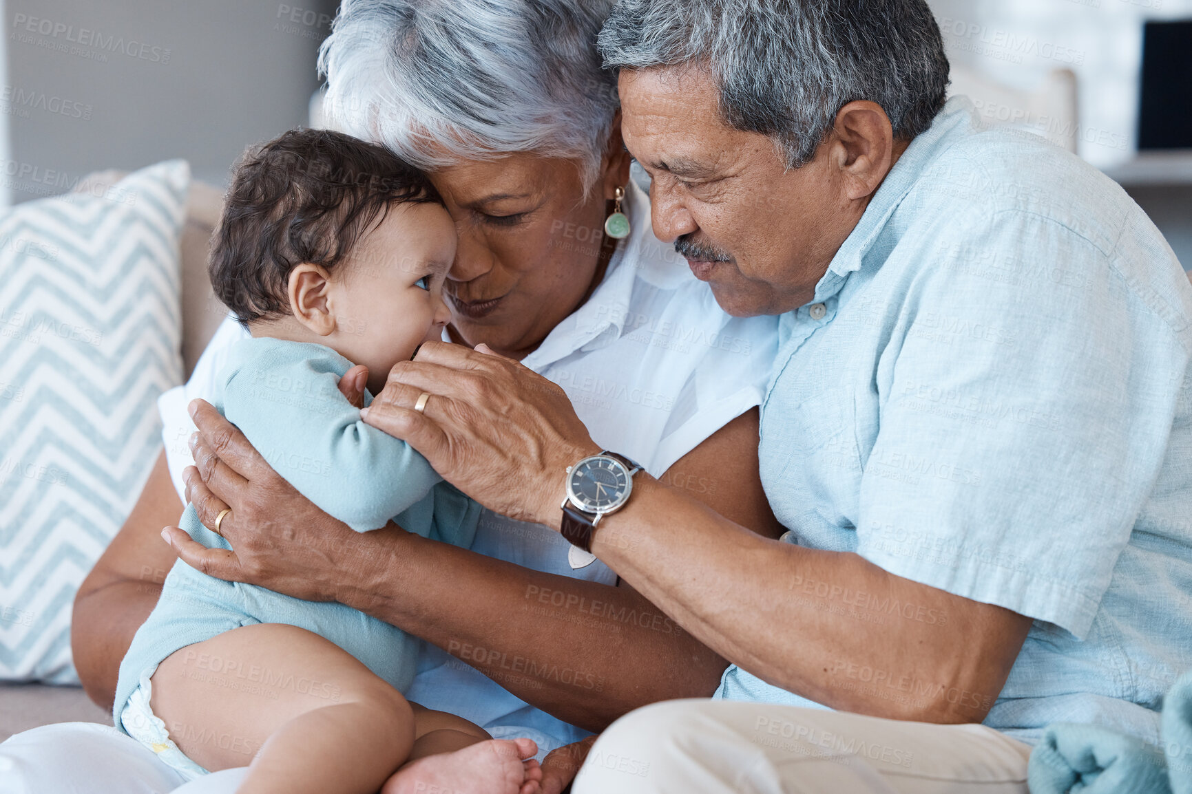 Buy stock photo Relax, care and grandparents with baby on sofa for bonding, smile and support. Love, happiness and generations with senior man and woman holding child in living room of family home together.