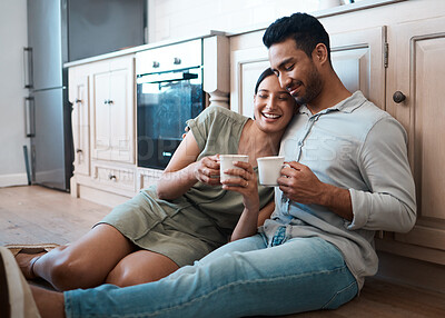 Buy stock photo Shot of a young couple having a cup of coffee together at home