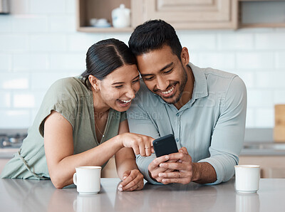 Buy stock photo Shot of a young couple using a phone together at home