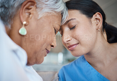 Buy stock photo Closeup shot of an attractive young female nurse sharing an intimate moment with her senior patient