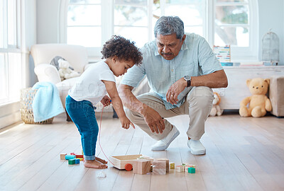 Buy stock photo Shot of a little girl playing with her grandfather at home