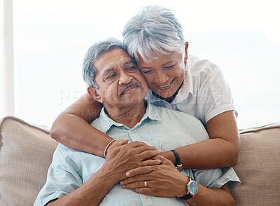 Buy stock photo Shot of a senior woman hugging her husband at home
