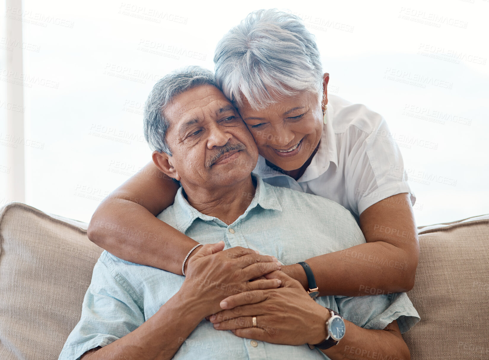 Buy stock photo Smile, elderly couple and hug in home for love, connection or bonding together on sofa. Senior man, happy woman or embrace for romantic commitment, marriage or relationship with partner in retirement