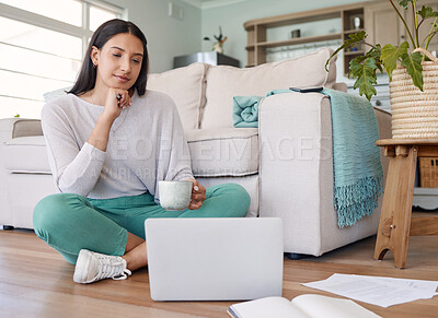 Buy stock photo Shot of a woman drinking coffee while sitting on the floor with her laptop