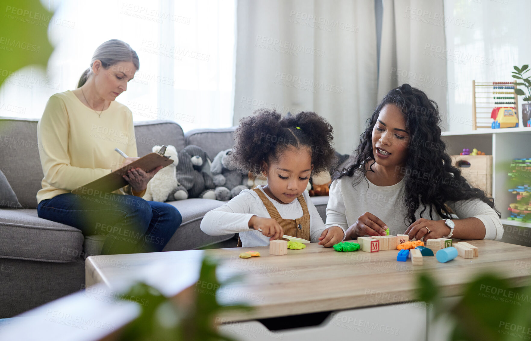 Buy stock photo Shot of a mature therapist observing how a young mother interacts with her daughter