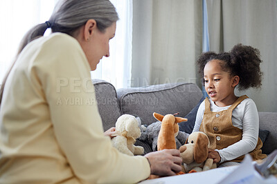 Buy stock photo Shot of a mature therapist encouraging her young patient to play with toys