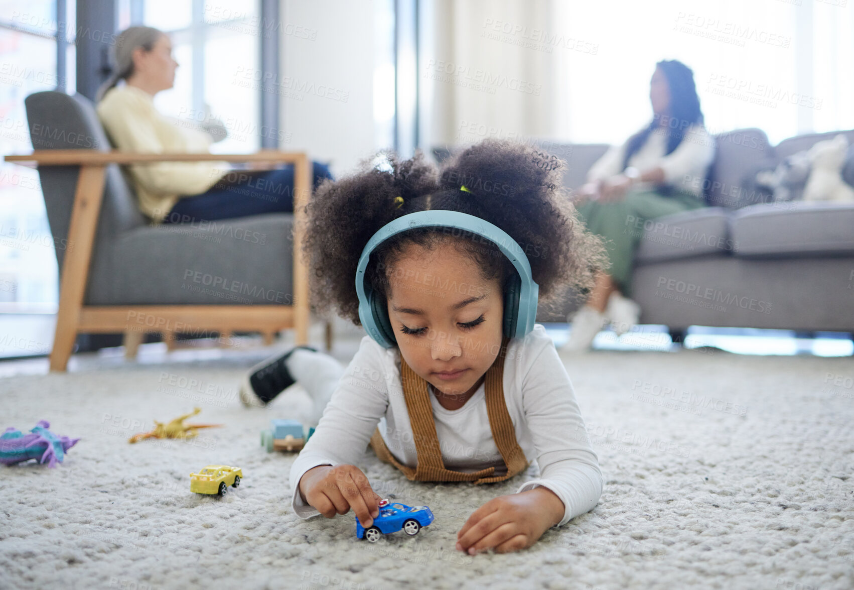 Buy stock photo Shot of a little girl drawing while her mom speaks a psychologist