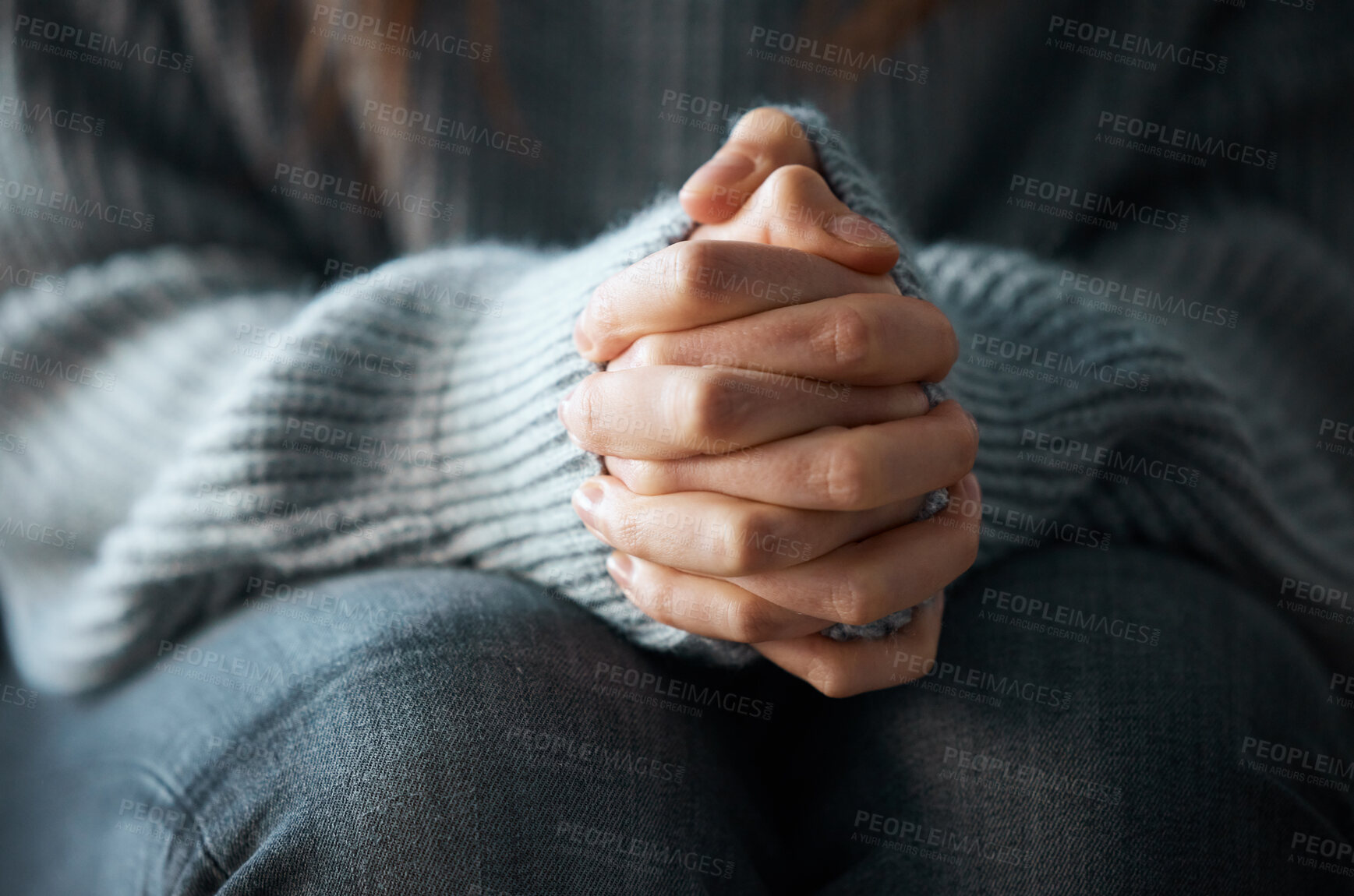 Buy stock photo Shot of a woman nervously clasping her hands together