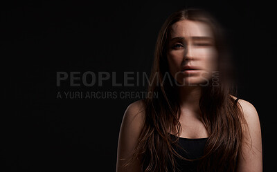 Buy stock photo Studio shot of a woman posing against a black background with a blurred face
