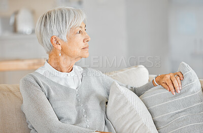 Buy stock photo Shot of a senior woman looking thoughtful at home