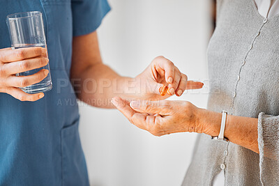 Buy stock photo Closeup shot of a nurse giving medication and a glass of water to a patient