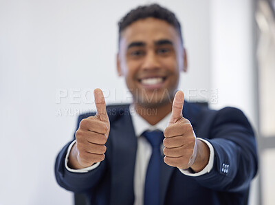 Buy stock photo Closeup shot of a young businessman showing thumbs up in an office