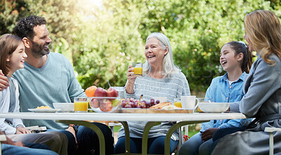 Buy stock photo Shot of a family having lunch outside