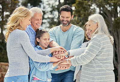 Buy stock photo Shot of a family stacking their hands in the garden outside