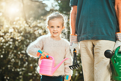 Buy stock photo Shot of an adorable little girl gardening with her grandfather