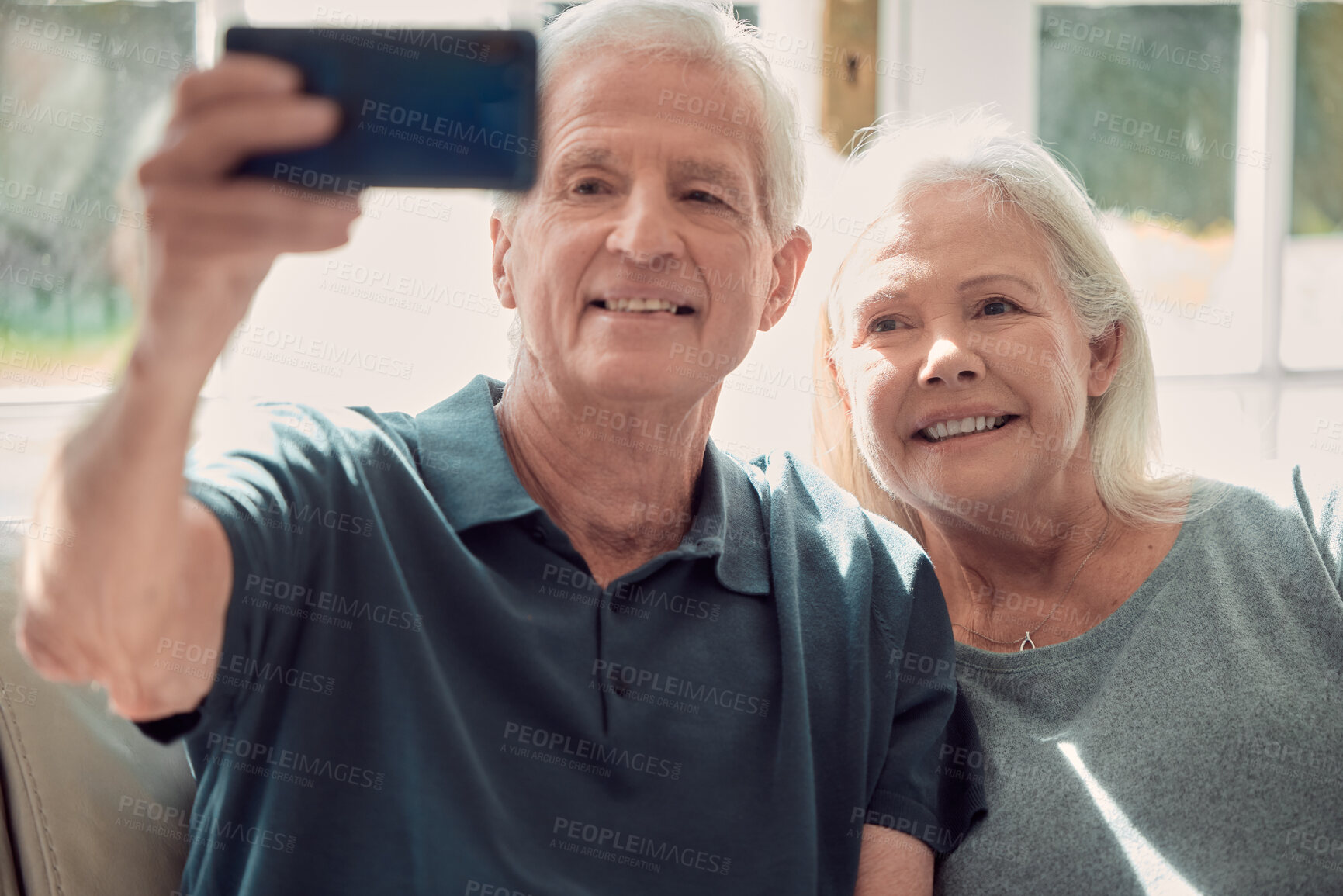 Buy stock photo Selfie, smile and elderly couple hug in home, living room and bonding or relax together with support. Retirement, holiday and senior man with mature woman with social media, peace or care in marriage