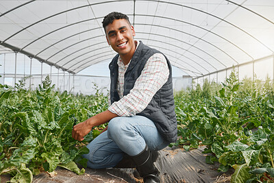 Buy stock photo Portrait of a young man tending to crops in a greenhouse on a farm