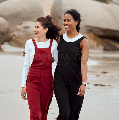 Buy stock photo Shot of two attractive young woman standing together on the beach