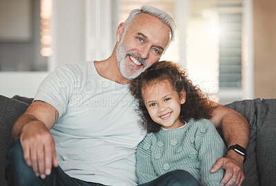 Buy stock photo Shot of a girl sitting at home with her grandfather