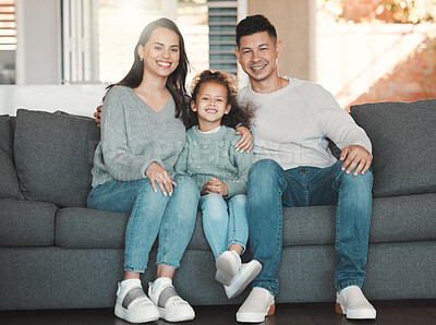 Buy stock photo Shot of a girl on a couch with her parents at home