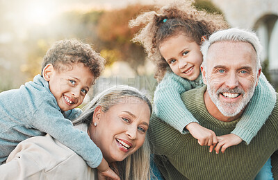 Buy stock photo Shot of a senior couple spending time outdoors with their grandchildren