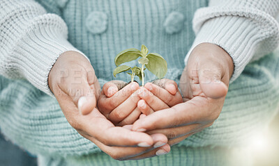 Buy stock photo Shot of a unrecognizable man and a little girl holding a plant outside