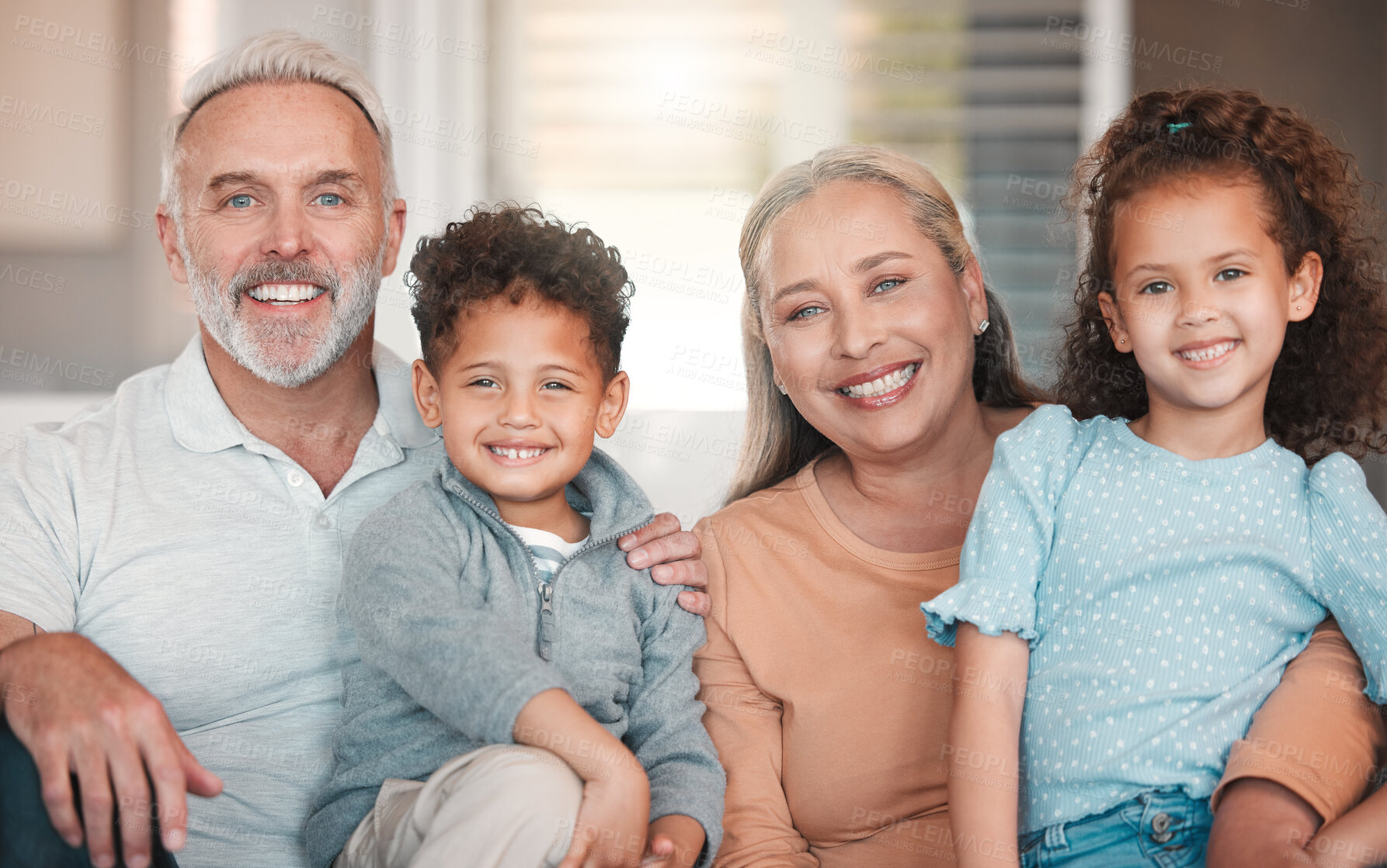 Buy stock photo Shot of two little siblings spending time with their grandparents at home