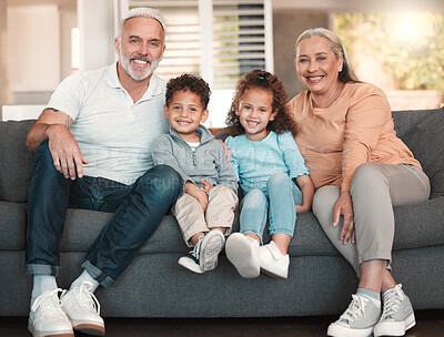 Buy stock photo Shot of two little siblings spending time with their grandparents at home