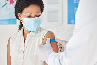 Buy stock photo Shot of a young woman getting a bandaid on her arm at a checkup at a clinic