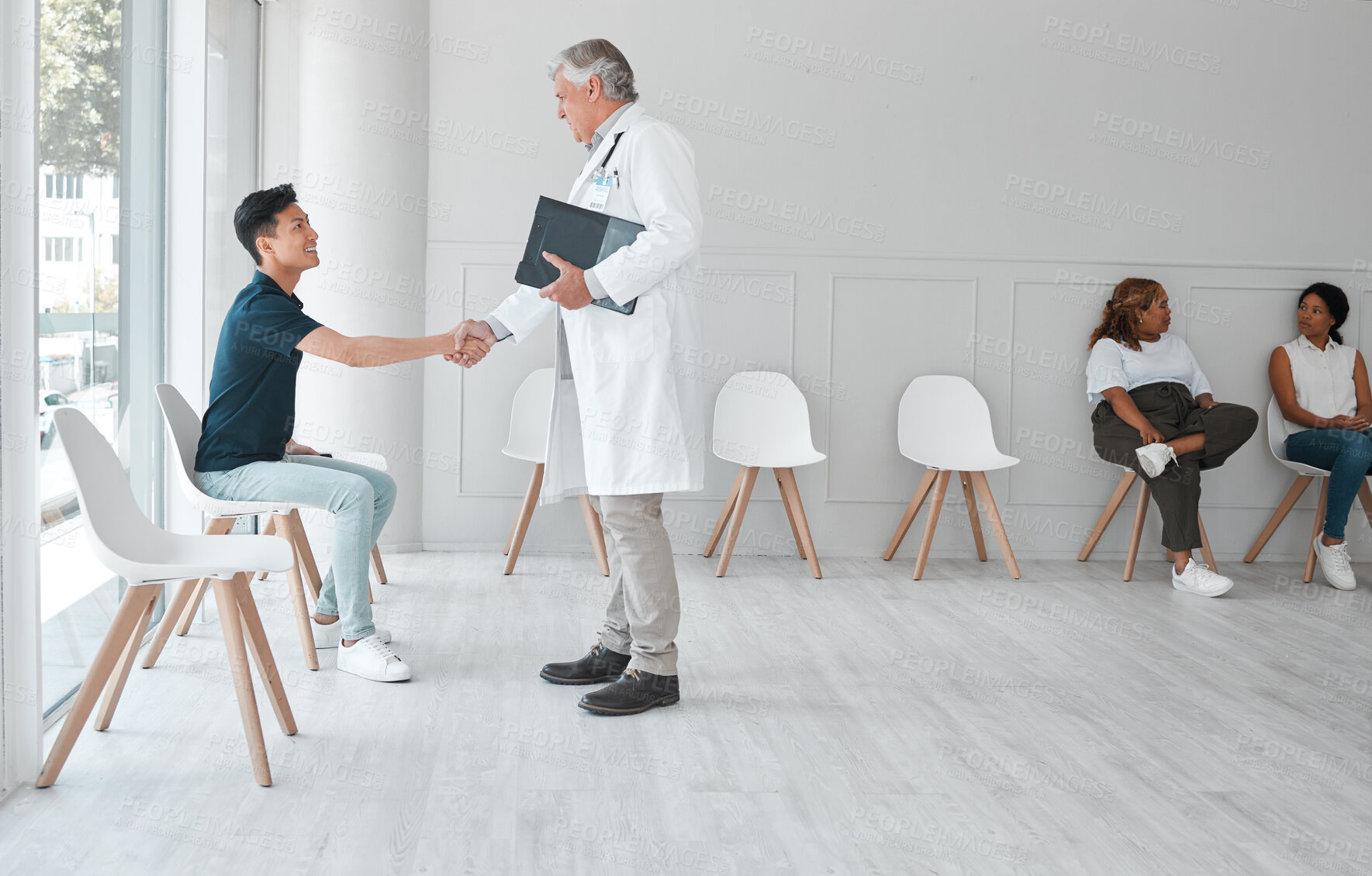 Buy stock photo Doctor, happy man and handshake with patient in hospital waiting room for greeting, appointment or checkup. Medical, mature professional and shaking hands for help, welcome or healthcare consultation