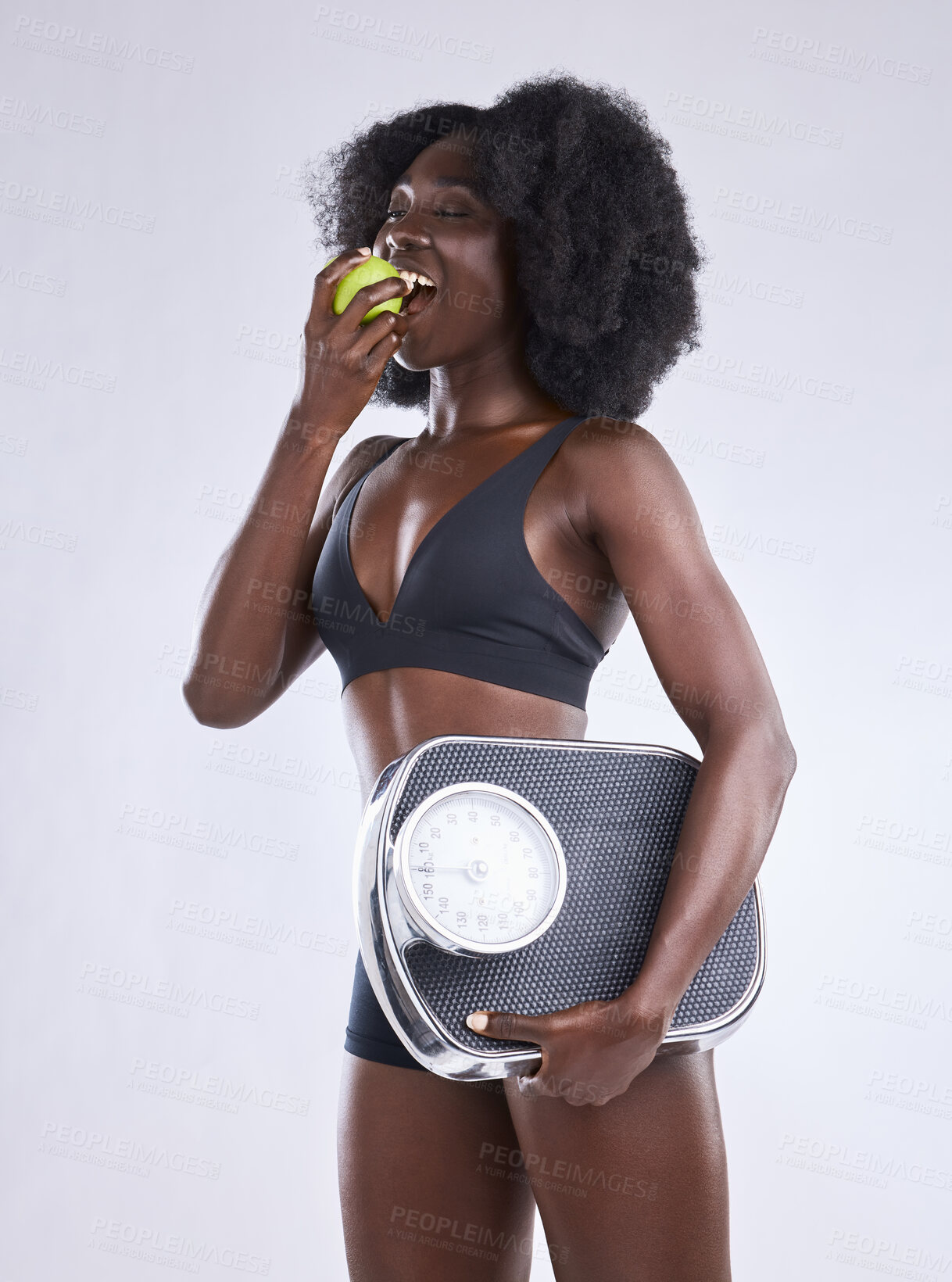 Buy stock photo Fitness, scale and black woman with apple in studio for wellness, gut health and diet, detox or balance on white background. Body, care and African model with organic, fruit or weight loss progress