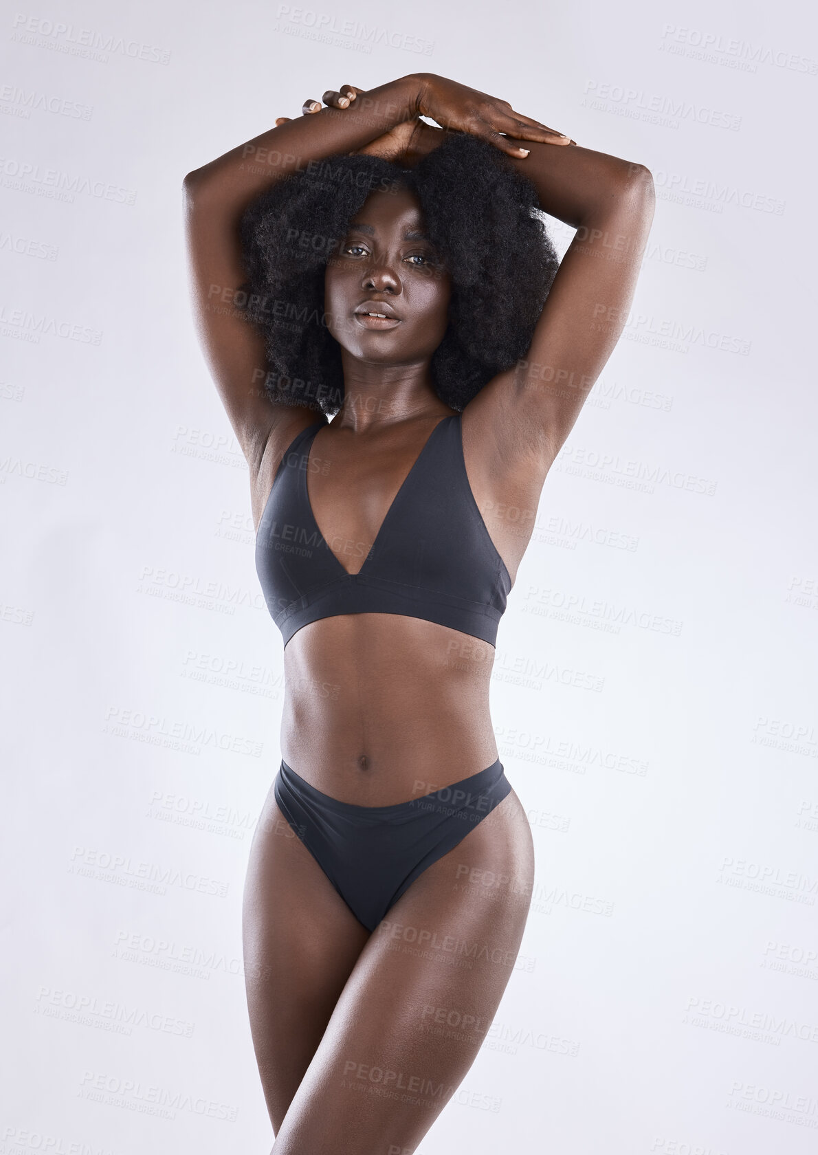 Buy stock photo Shot of a young woman posing in her underwear against a studio background