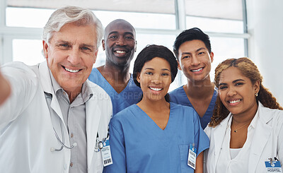 Buy stock photo Portrait of a group of medical practitioners taking selfies together in a hospital