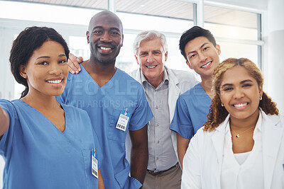 Buy stock photo Portrait of a group of medical practitioners taking selfies together in a hospital