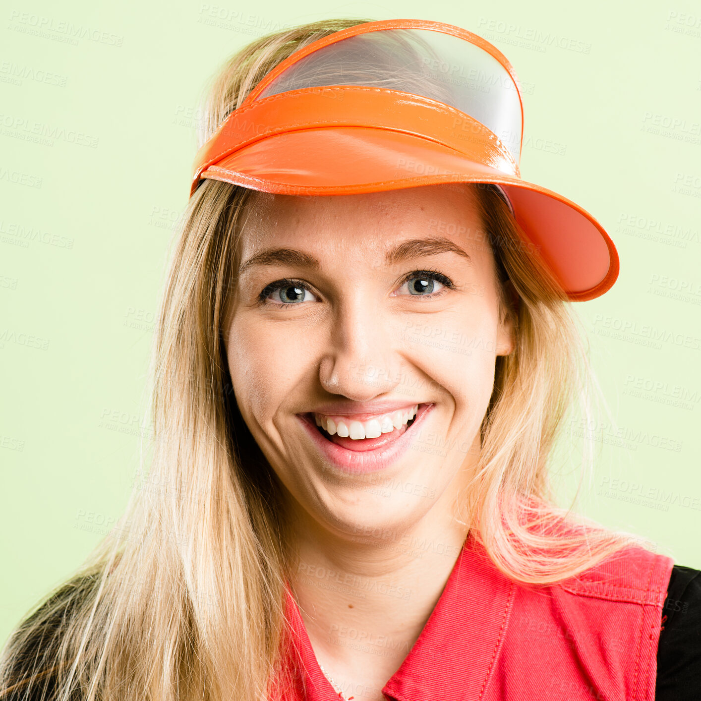 Buy stock photo Woman, portrait and happy with visor, quirky fashion and smile with funky style in studio. Hat, confidence and female person from Germany with hipster, fun and cool accessory with green background