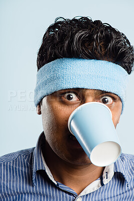 Buy stock photo Funny, crazy and portrait of man with coffee cup in studio for fitness with retro headband for workout. Caffeine, goofy and athlete drink takeaway cappuccino or latte with vintage exercise fashion.